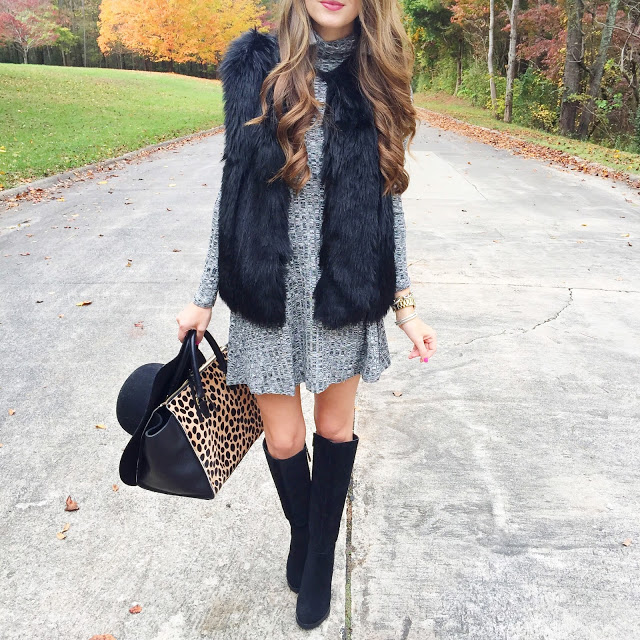 Black faux fur vest over grey dress