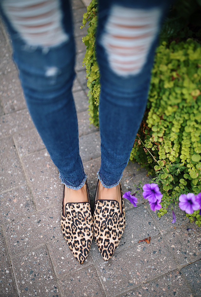 Blue jeans, beige knitted sweater, black lace bra, black loafers