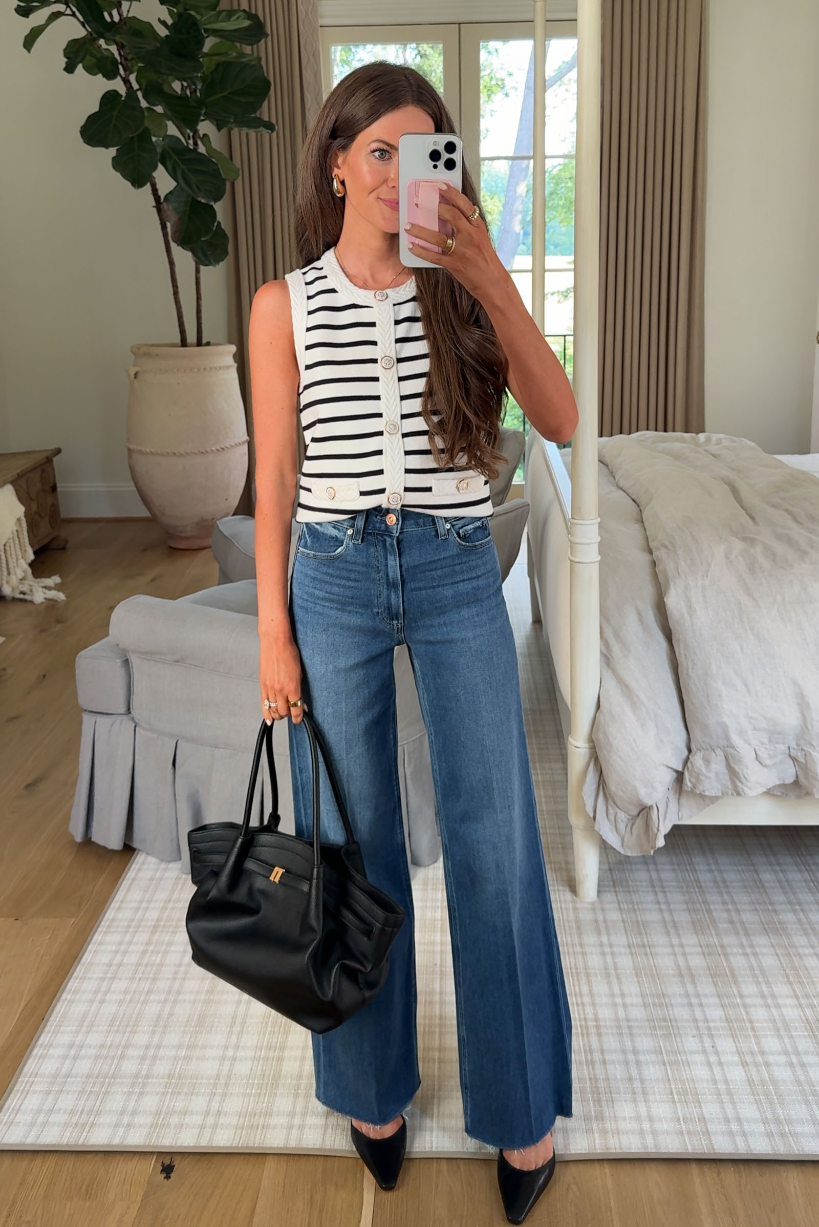 Southern Curls & Pearls wearing Stripe Crewneck Sweater Vest, Paige Anessa High-Waist Raw Hem Wide-Leg Jeans, and JW PEI Medium Hana Faux Leather Tote from the Nordstrom Anniversary Sale 2025.