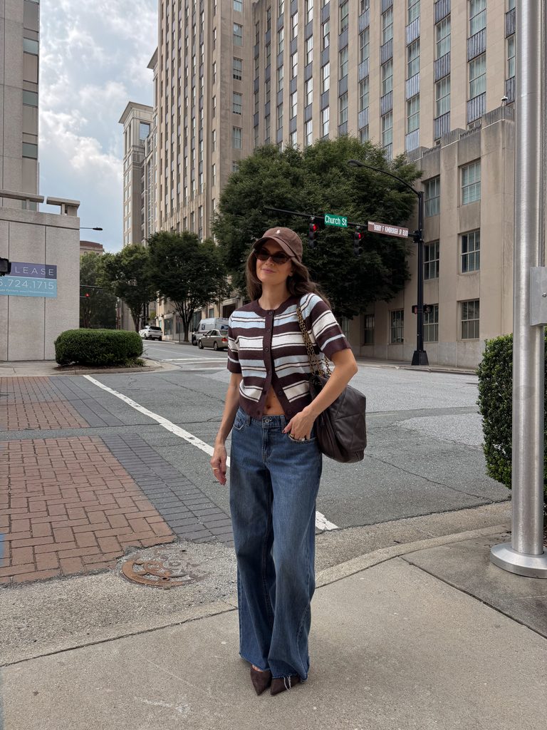striped short sleeve cardigan with loose jeans, brown heels, and a baseball hat for fall 2026